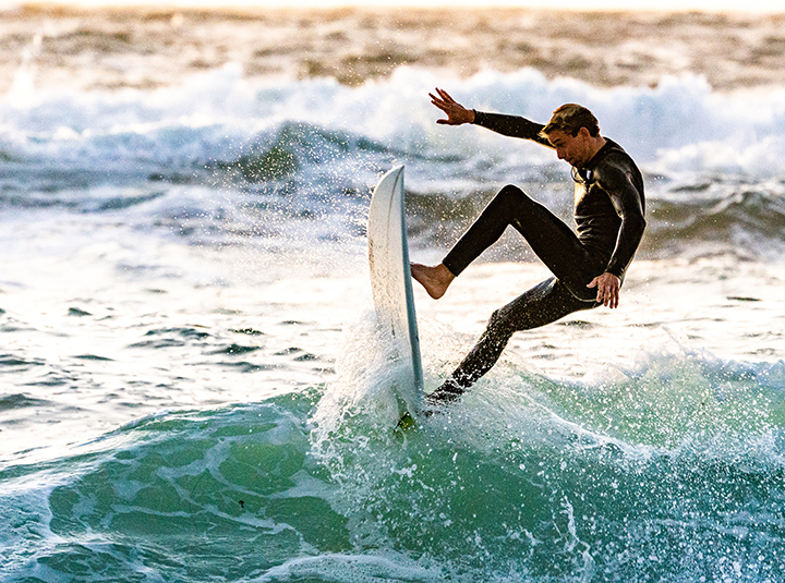 Prancha de surf e equipamento de kitesurf na praia